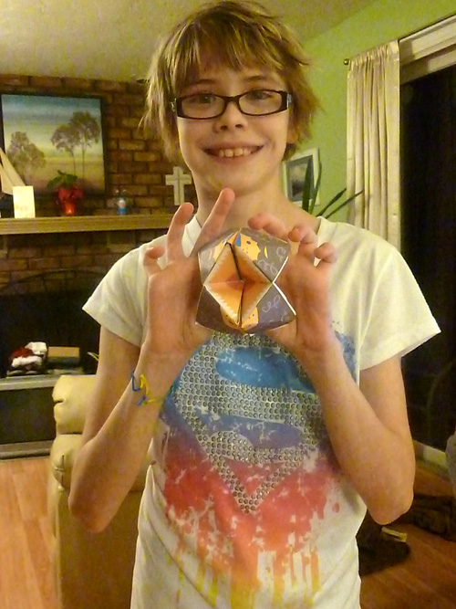 A paper fortune-teller shaped like a lion with its mouth open