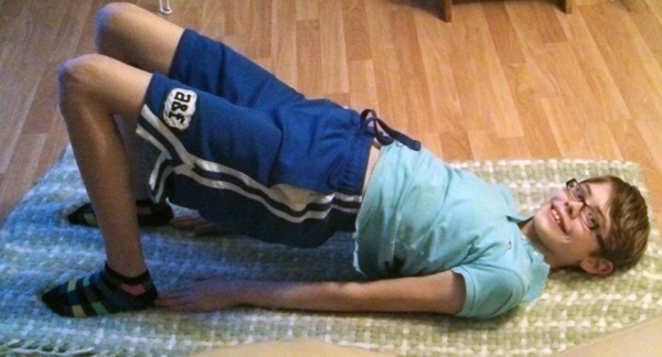 Teenage daughter doing yoga in the living room